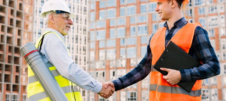 Side View Men With Safety Vests Shaking Hands